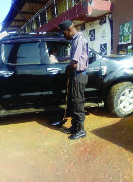 INS security guard on duty beside a client vehicle